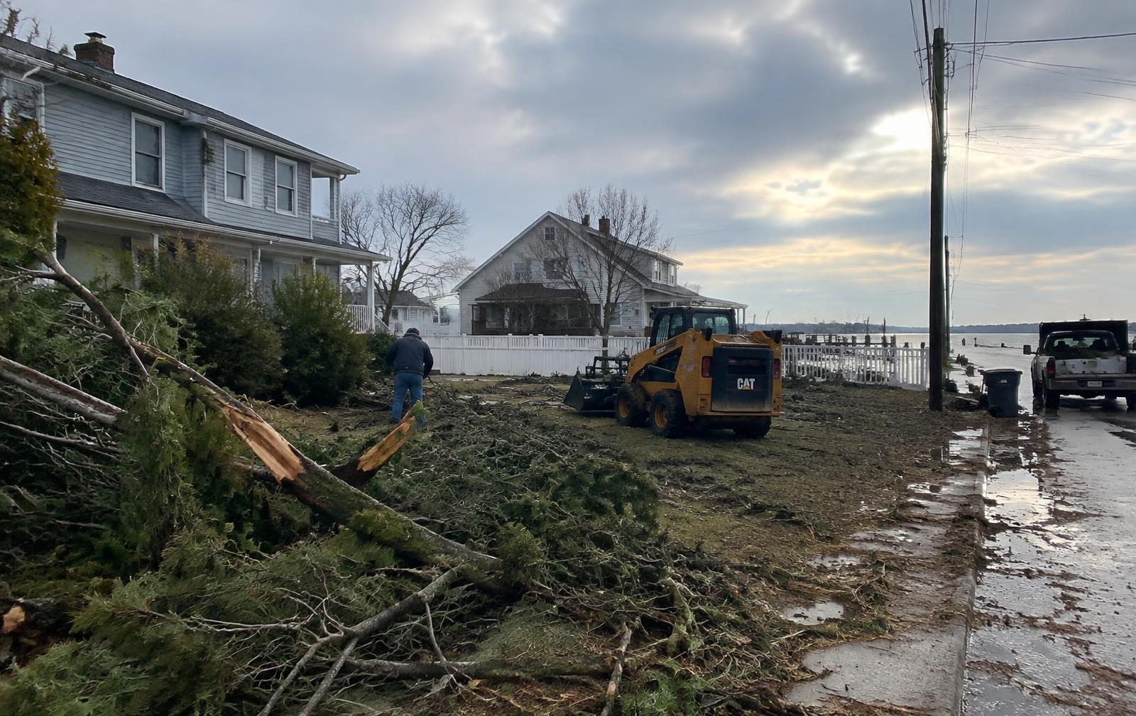 Storm debris being cleared from a coastal New Jersey yard